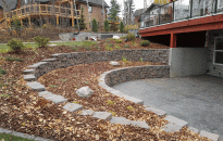A two-tiered rock wall and shrub beds creates a beautiful patio for the walkout basement.
