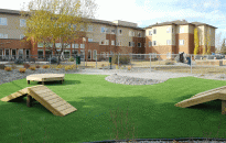 Residents can sit on the patio and watch their dogs enjoy the artificial turf and structures.