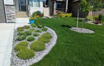 Front Yard Landscaping with a Roman paver garden edge.