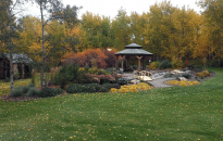 Pavilion Garden in the fall. Bridges leads you over the creek to the patio as you walk through the perennials and shrubs.